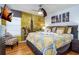 Bright bedroom with a New York City theme featuring a queen bed, mounted television, and ceiling fan at 7912 Golden Pond Cir, Kissimmee, FL 34747