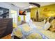 Comfortable bedroom with bright yellow wall decor, sleek furnishings, and a flat-screen TV for entertainment at 7912 Golden Pond Cir, Kissimmee, FL 34747