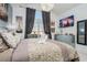 Comfortable bedroom featuring a large window, stylish decor, and ample natural light at 7912 Golden Pond Cir, Kissimmee, FL 34747