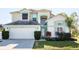 Charming two-story home with a well-manicured lawn and attached two-car garage at 7912 Golden Pond Cir, Kissimmee, FL 34747