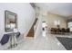 Inviting foyer featuring tile flooring, staircase, and decorative mirror, creating a welcoming entrance at 7912 Golden Pond Cir, Kissimmee, FL 34747
