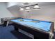 Spacious game room with a pool table, air hockey, and blue carpet at 7912 Golden Pond Cir, Kissimmee, FL 34747