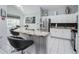 Modern kitchen with granite countertops, stainless steel appliances, and sleek bar stools at 7912 Golden Pond Cir, Kissimmee, FL 34747