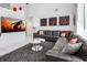Bright living room featuring a large sectional sofa, modern art, and a wall-mounted television at 7912 Golden Pond Cir, Kissimmee, FL 34747