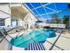 Inviting screened-in pool area with ample seating, relaxing hot tub, and lush greenery at 7912 Golden Pond Cir, Kissimmee, FL 34747