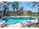 Inviting screened-in pool area with comfortable lounge chairs and serene backyard view at 7912 Golden Pond Cir, Kissimmee, FL 34747