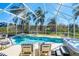 Inviting screened-in pool area with comfortable lounge chairs and a relaxing hot tub at 7912 Golden Pond Cir, Kissimmee, FL 34747