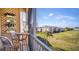 Cozy balcony with seating offering relaxing views of the community's manicured lawn at 8103 Coconut Palm Way # 203, Kissimmee, FL 34747