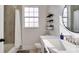 Contemporary bathroom with a window, floating shelves, and a vanity at 8103 Coconut Palm Way # 203, Kissimmee, FL 34747