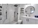 Modern bathroom featuring marble tile, a sleek shower system, and floating shelves at 8103 Coconut Palm Way # 203, Kissimmee, FL 34747