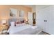 A modern bedroom with a grey headboard, accent pillows, and stylish bedside tables at 8103 Coconut Palm Way # 203, Kissimmee, FL 34747