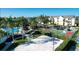Aerial view showcasing sand volleyball, basketball court, picnic tables, and pool at 8103 Coconut Palm Way # 203, Kissimmee, FL 34747
