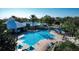 Aerial view of a sparkling community pool with lounge chairs and resort-style amenities at 8103 Coconut Palm Way # 203, Kissimmee, FL 34747