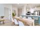 Dining area adjacent to an open kitchen featuring a modern table and contemporary lighting at 8103 Coconut Palm Way # 203, Kissimmee, FL 34747