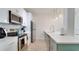 Modern kitchen with stainless steel appliances, tile backsplash, and white cabinets at 8103 Coconut Palm Way # 203, Kissimmee, FL 34747
