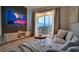 Cozy living room with modern decor, a balcony, and a large screen television at 8103 Coconut Palm Way # 203, Kissimmee, FL 34747
