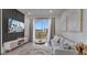 Comfortable living room featuring an outdoor balcony and a wall mounted television at 8103 Coconut Palm Way # 203, Kissimmee, FL 34747