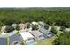 Aerial view of homes, pools, and lush greenery in a neighborhood at 838 Sandy Ridge Dr, Davenport, FL 33896