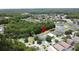 Aerial view with houses near pond and green space surrounded by trees in neighborhood at 838 Sandy Ridge Dr, Davenport, FL 33896