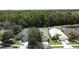 An aerial shot showcasing two houses with screened-in pools and beautiful green landscaping at 838 Sandy Ridge Dr, Davenport, FL 33896