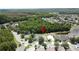An aerial view of houses near green space and a pond in a neighborhood at 838 Sandy Ridge Dr, Davenport, FL 33896