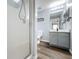 Bathroom featuring a glass-enclosed shower, gray vanity with sink, and wood-look flooring at 838 Sandy Ridge Dr, Davenport, FL 33896