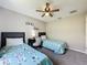 Bedroom with two twin beds, a ceiling fan, a window with curtains, and neutral-colored walls at 838 Sandy Ridge Dr, Davenport, FL 33896