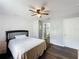 Bedroom with neutral walls, a ceiling fan, dark wood-look flooring, and a queen-sized bed at 838 Sandy Ridge Dr, Davenport, FL 33896
