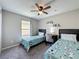 Bedroom with two twin beds, a ceiling fan, a window with curtains, and neutral-colored walls at 838 Sandy Ridge Dr, Davenport, FL 33896