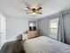Bedroom featuring a ceiling fan, a window with curtains, and neutral-colored walls at 838 Sandy Ridge Dr, Davenport, FL 33896