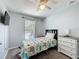 Bedroom with a ceiling fan, neutral walls, and a window view of the screened-in pool area at 838 Sandy Ridge Dr, Davenport, FL 33896