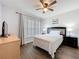 Cozy bedroom featuring a ceiling fan, wood floors, and bright natural light at 838 Sandy Ridge Dr, Davenport, FL 33896