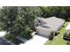 Aerial view of a charming single-Gathering home with a lush green yard at 838 Sandy Ridge Dr, Davenport, FL 33896