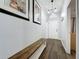 Welcoming hallway with wood flooring and elegant lighting leading to the front door and other areas at 838 Sandy Ridge Dr, Davenport, FL 33896