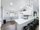 Modern kitchen with white cabinets, quartz countertops, stainless steel sink, and modern lighting fixtures at 838 Sandy Ridge Dr, Davenport, FL 33896