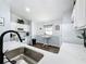 Kitchen with white upper cabinets, light grey lower cabinets, white appliances and a breakfast table near window at 838 Sandy Ridge Dr, Davenport, FL 33896