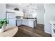 Bright kitchen featuring white appliances, light grey cabinets, modern lighting, and wood-look flooring at 838 Sandy Ridge Dr, Davenport, FL 33896