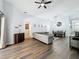 Spacious open-concept living area with wood flooring, high ceilings, and a ceiling fan with great natural light at 838 Sandy Ridge Dr, Davenport, FL 33896