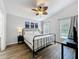 Bedroom with a ceiling fan and two windows overlooking the pool at 838 Sandy Ridge Dr, Davenport, FL 33896