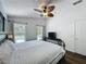 Bedroom with a ceiling fan and windows overlooking the pool at 838 Sandy Ridge Dr, Davenport, FL 33896