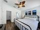 Bedroom with a ceiling fan, wood floors, and ensuite bathroom at 838 Sandy Ridge Dr, Davenport, FL 33896