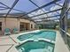 Inviting screened-in pool and spa area featuring a covered lanai perfect for outdoor entertaining and relaxation at 838 Sandy Ridge Dr, Davenport, FL 33896