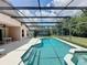 Covered pool with built in jacuzzi and outdoor lounge area at 838 Sandy Ridge Dr, Davenport, FL 33896