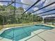 Screened-in pool with an attached spa and view of the private backyard at 838 Sandy Ridge Dr, Davenport, FL 33896