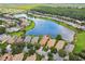 Beautiful lakefront community with homes boasting lush lawns and mature trees at 925 Grand Canal Dr, Poinciana, FL 34759