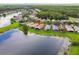 Lakefront property featuring screened in lanai and well-maintained lawns at 925 Grand Canal Dr, Poinciana, FL 34759