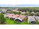 Aerial view of several homes highlighting backyard screened patios and scenic surroundings at 925 Grand Canal Dr, Poinciana, FL 34759