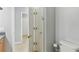Bathroom featuring bi-fold door, toilet, and tiled flooring that extends through hallway at 925 Grand Canal Dr, Poinciana, FL 34759