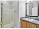 Bathroom featuring a tub and shower, light gray walls, and a wooden vanity at 925 Grand Canal Dr, Poinciana, FL 34759