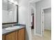 Bathroom vanity and sink, with a glimpse into adjacent rooms through the doorway at 925 Grand Canal Dr, Poinciana, FL 34759